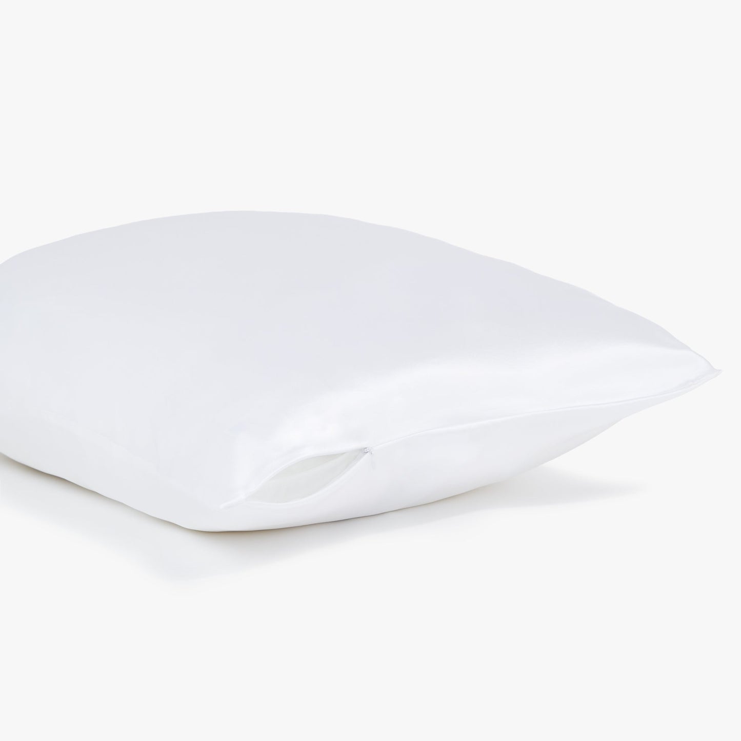 Side view of the white Silk pillowcase from Dore and Rose showing the zipper